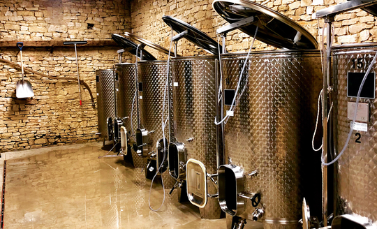 Large stainless steel tanks in the vinification room of Pierre-Henri Rougeot