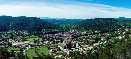 Wide landscape shot of Provence in France, hills in the background and a whole village below