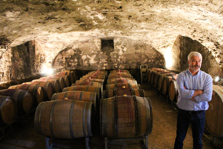 Jean-Marc Lafont standing in his barrel room