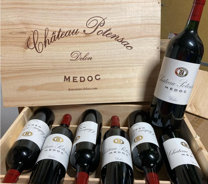 Box full of Chateau Potensac wines, wooden box with their label on it