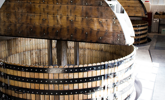 Large wooden vat in the vinification room of Champagne Dehours