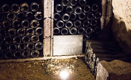 Piles of bottles in the wall in the cellar of Domaine le Petit Saint Vincent
